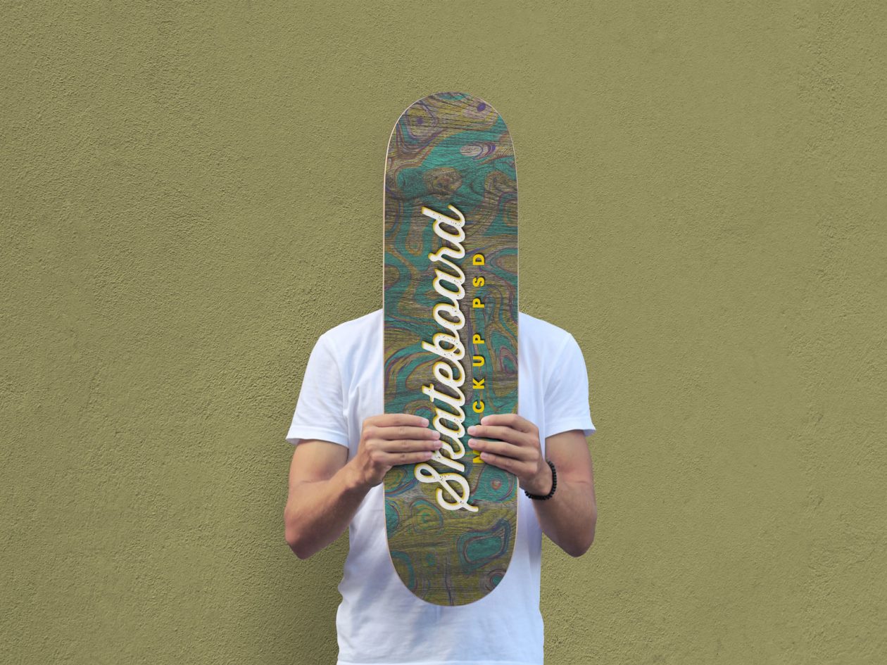 Free Man Holding Skateboard Mockup PSD - Designbolts