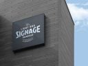 Free Wall Mounted Company Logo Signage Board on Building Mockup PSD ...