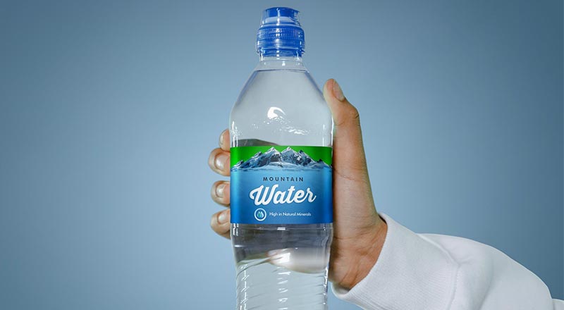 Free Hand Holding Water Bottle Label Mockup PSD - Designbolts