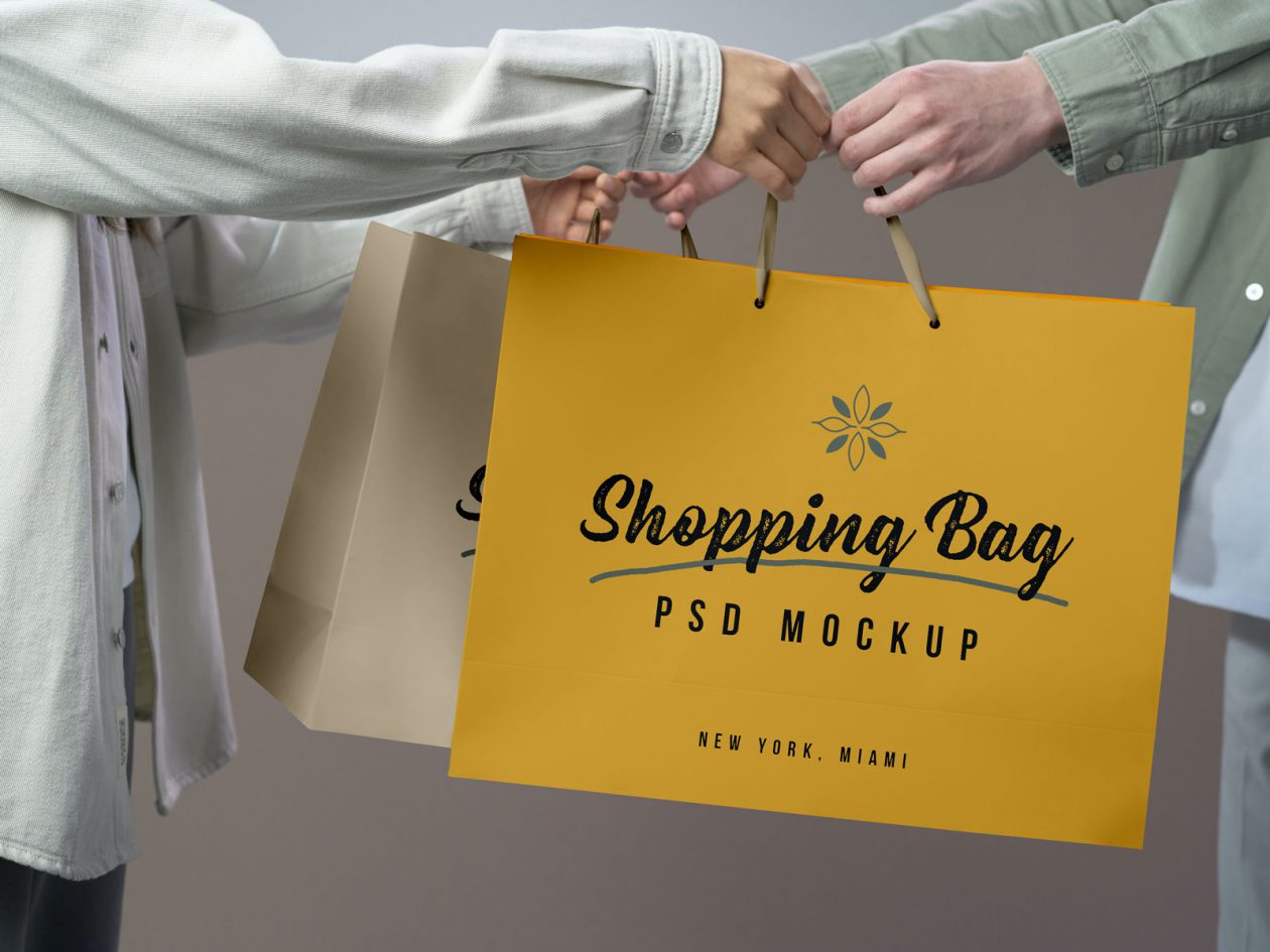 Free Hand Holding Shopping Bag Mockup PSD - Designbolts